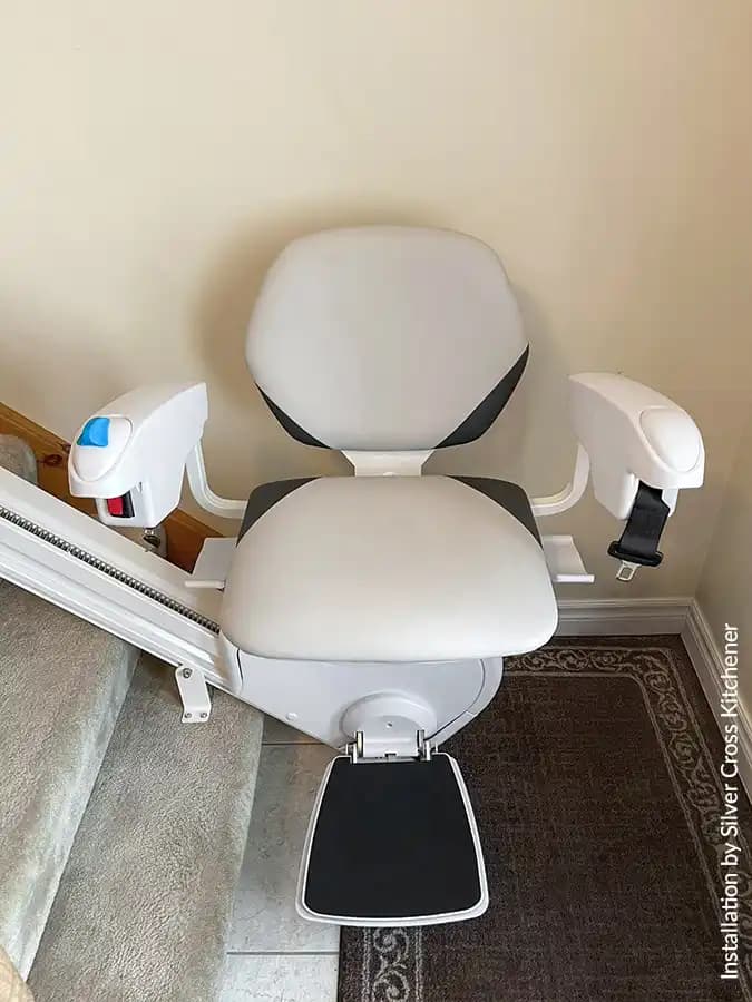 Savaria Handicare 4000 twin-rail curved stairlift with Simplicity Seat in sand upholstery, folded armrests and seat, compact 16.25-inch profile viewed from above