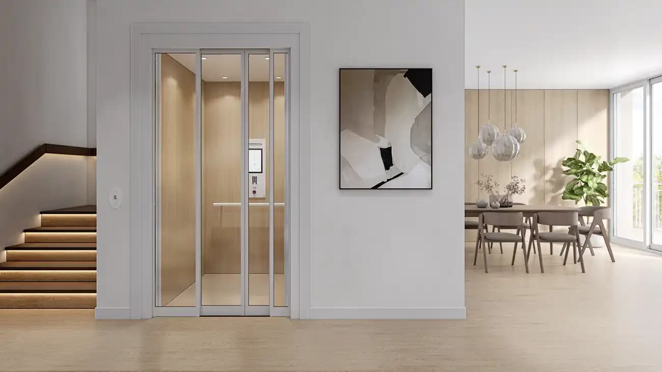 Savaria home elevator with automatic sliding glass doors and white frame in modern luxury residence near dining area and illuminated staircase