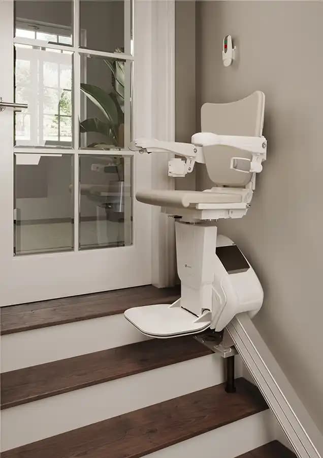 Savaria Handicare 1100 straight stairlift with Style Seat, Zero Intrusion system, slim covered rail eliminating doorway obstruction at top landing on modern wood stairs